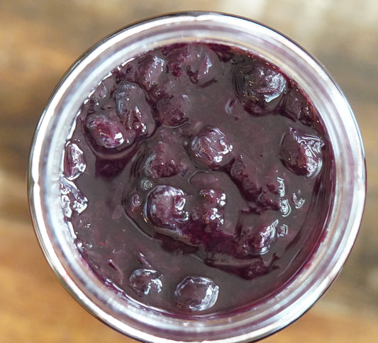 Open Jar of Blueberry Sunrise which has soft chunky pieces of blueberry, mandarin which is not visible, and tequila