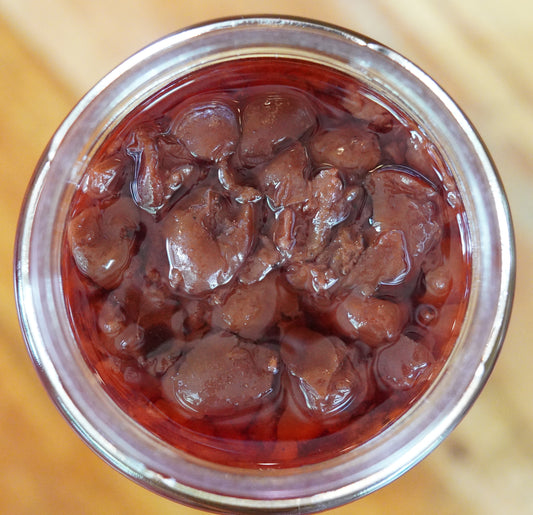 Sour Cherry Vieux Carre in an open jar, which has soft chunky pieces of Sour Cherries with it's jelly formed from the juice, blood oranges and cognac